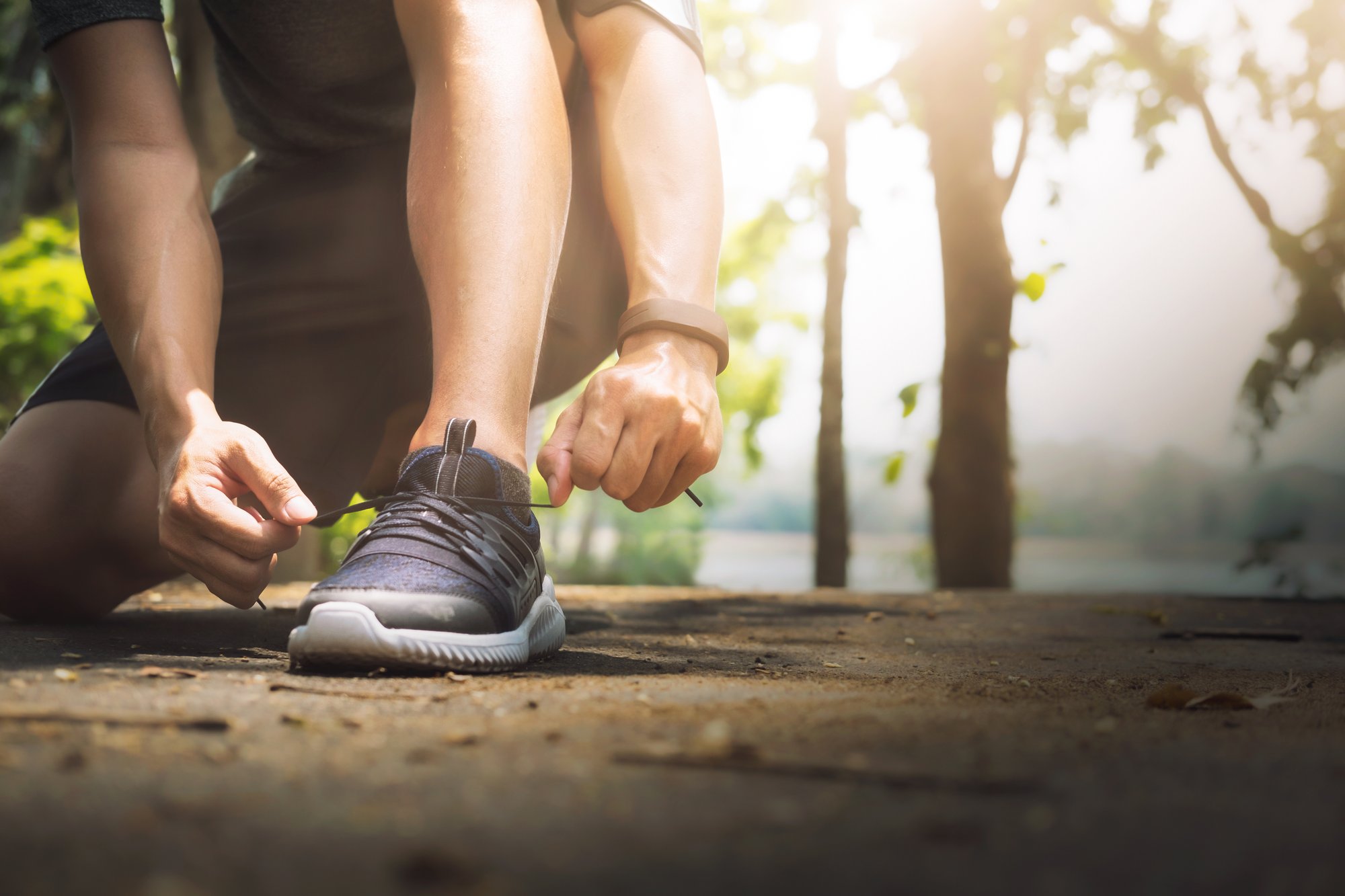 young-man-runner-tying-shoelaces